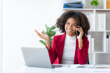 Smiling Businesswoman enjoying talking on the phone in the office.