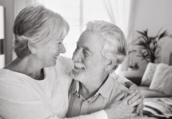 Wall Mural - Loving old senior family couple bonding embracing. Happy nice elderly man and woman hugging while being in a great mood at home