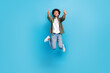 Full length body photo of jumping overjoyed friendly man thumbs up wear stylish outfit positive crazy isolated on blue color background