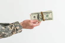 Army Soldier Holding Money Against White Background