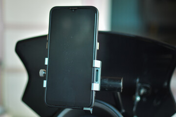 smartphone holder on the motorcycle. Smartphone with black screen. 