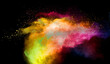 Multicolored powder explosion on black background.Colorful red yellow splash cloud on background.