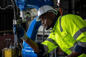 Aufkleber - Engineer working with robot arm automated welding machine in modern metal factory.