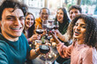 © Nicolas Micolani - Multiracial friends drinking and toasting red wine at bar table- Group of happy young people taking selfie picture at restaurant-Life style concept with youth guys enjoying happy hours
