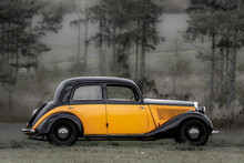 Retro Style Photo Of A Classic Oldtimer Vintage Car Of The 1930s - 1940s In A Forest