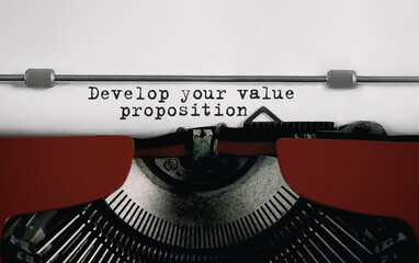 Poster - text develop your value proposition typed on retro typewriter