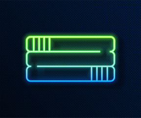 Wall Mural - Glowing neon line Towel stack icon isolated on blue background. Vector