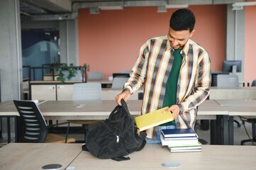 Wall Mural - Handsome and young indian Male college student.