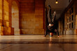 © Alberto - boy in his teens break dancing on a tiled floor in the arcades of a historic building. street dancer. youth culture and hip-hop culture. B-boy.