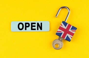 Poster - On the yellow surface is an open lock with a key and a sticker with the inscription - open