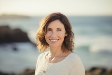 Wall Mural - Portrait of smiling woman standing on the beach at the day time