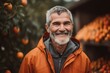 © Leon Waltz - Portrait of a senior man in an orange jacket on a farm.