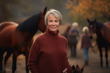 Group portrait photography of a pleased woman in her 50s wearing a cozy sweater against an equestrian or horse background. Generative AI
