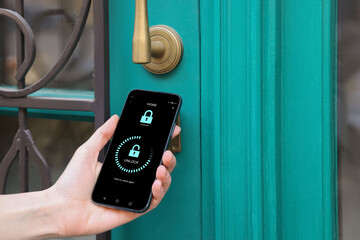 Woman unlocking door using mobile phone, closeup. Illustration of closed and open padlocks on device screen