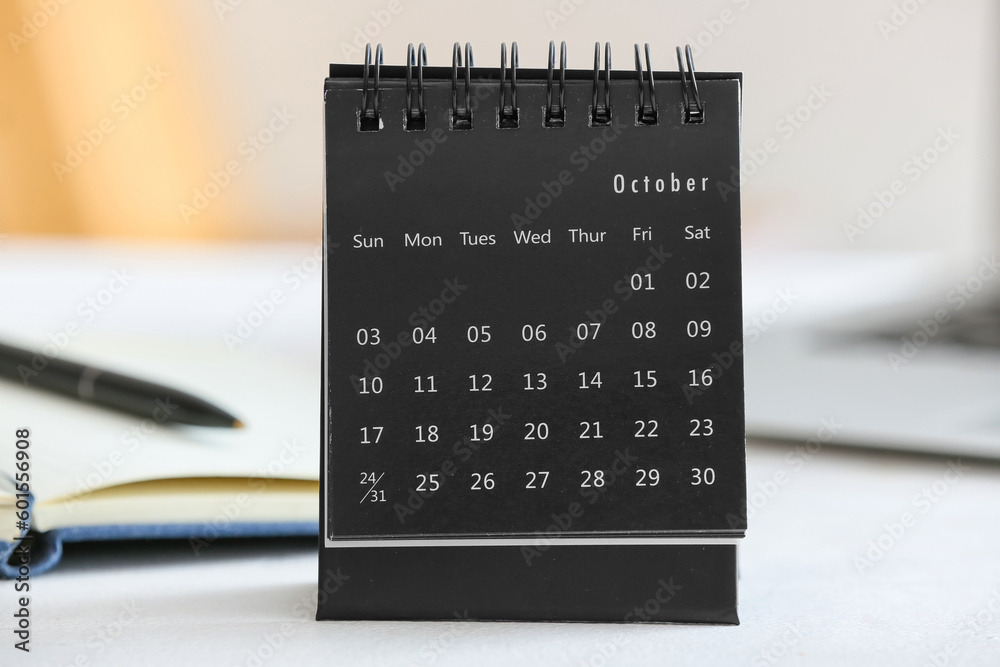 Flip paper calendar for October on table, closeup
