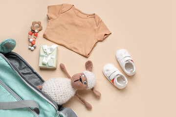 Wall Mural - Composition with baby clothes and toys on beige background