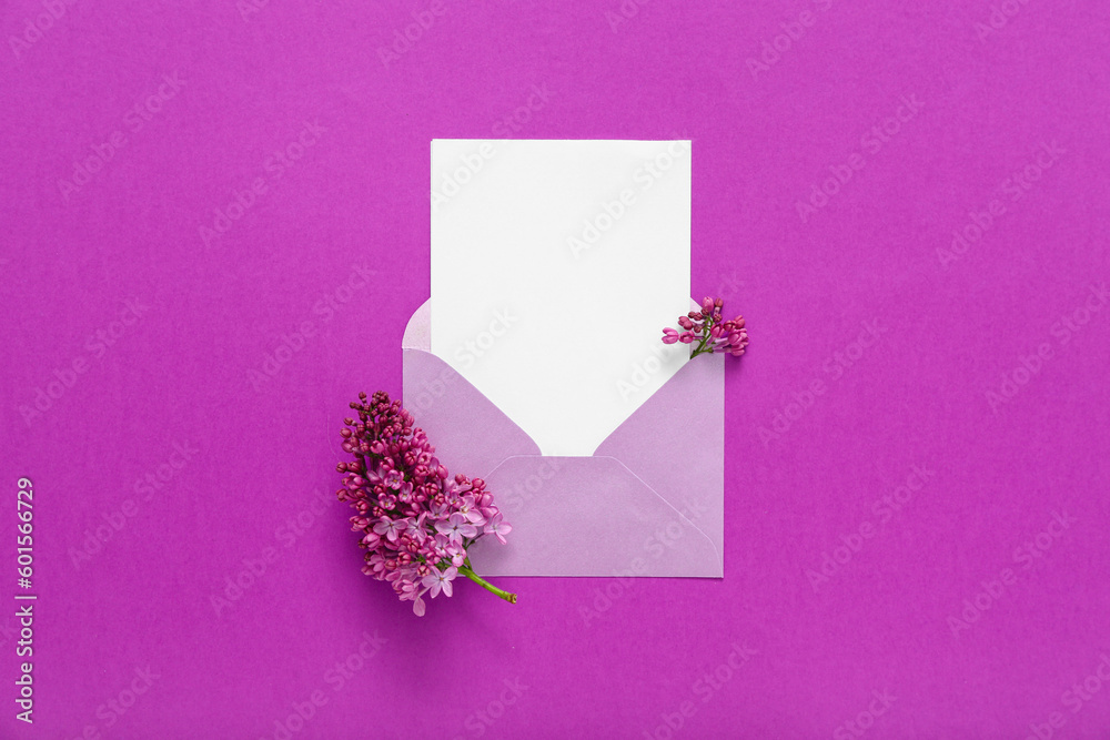 Envelope with blank card and beautiful lilac on purple background
