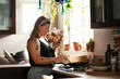 © Chanelle Malambo/peopleimages.com - Happy, woman cooking food with smartphone and in kitchen of a home. Dinner or lunch, multitasking and plus size, natural person with tattoo on cellphone following recipe motivation for healthy diet