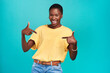 © Chanelle Malambo/peopleimages.com - Portrait, crazy and pointing with a black woman in studio on a blue background looking carefree or silly. Smile, fashion and fun with a happy young female hipster feeling confident or playful