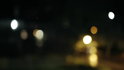 sparse water droplets drip from above pleasant bokeh blurry background