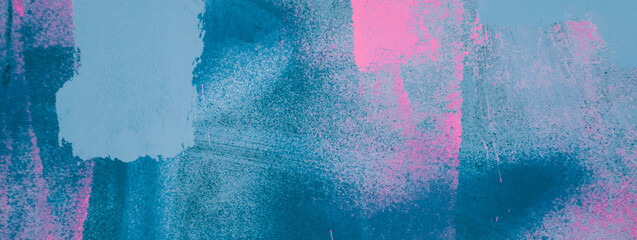Messy paint strokes and smudges on an old painted wall background. Abstract wall surface with part of graffiti. Colorful drips, flows, streaks of paint and paint sprays