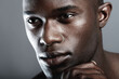 Art, beauty and serious face of black man on dark background with skin care, and dermatology. Health, wellness and male skincare cosmetics and fit, healthy African model closeup on studio backdrop.