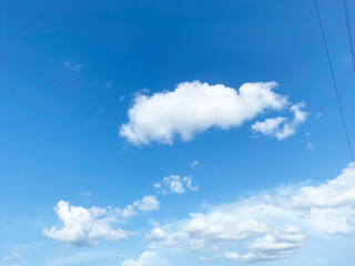 Wall Mural - Beautiful clouds during spring time in a Sunny day. Blue sky and white fluffy clouds