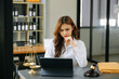 © Nuttapong punna - Beautiful asian woman lawyer working and gavel, tablet, laptop in front, Advice justice and law concept.