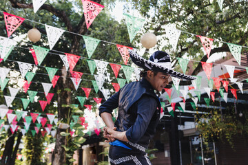 Wall Mural - Mexican man dancing and wearing Traditional mariachi costume at parade or cultural Festival in Mexico Latin America, hispanic people in independence day or cinco de mayo