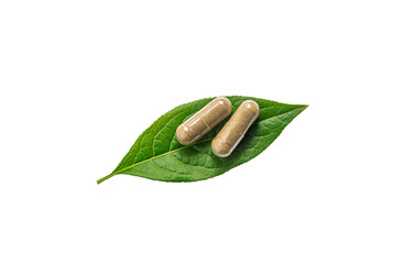 Wall Mural - Herb supplement capsules on green leaf isolate on white background. Selective focus.