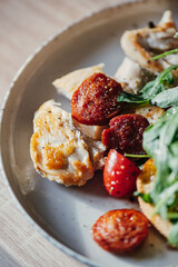 Wall Mural - Fried chicken fillet and fresh vegetable salad of tomatoes and arugula leaves.