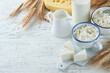© kasia2003 - Shavuot jewish holiday celebration. Kosher fresh dairy products milk and cheese, ripe wheat, cream on white wooden background. Dairy products over white wooden background. Shavuot concept. Top view.