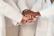 Teamwork in Action: Close-Up of United Hands in Lab Coats, Faces not Visible