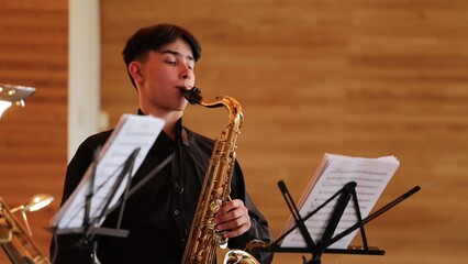 Poster - Russia Vyborg 04.05.2023 a musician in a black suit plays the saxophone