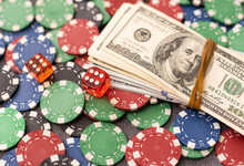 Poker Chips And Dollar Bills On Casino Table. Gambling. Poker As A Game Of Professionals. Responsibility For Games.