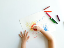 Small Child Draws With Pastel Crayons On White Table. Fathers Day