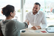 © Jeff Bergen/peopleimages.com - Meeting, handshake and business people in partnership, clients contract and agreement sign for career success. Happy professional man shaking hands with woman in job hiring, recruitment and interview
