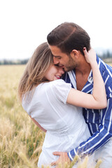 Poster - Portrait of a young Couple hugging and kissing eachotherr in the park