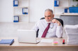 © Elnur - Old male employee and too much work in the office