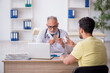 © Elnur - Young male patient visiting old male doctor