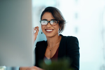 Business woman, happy and computer in glasses reflection for reading, online review and editor analysis or news. Smile of biracial person or professional worker with website or results on desktop pc