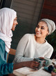 Friends, coffee and happy with Muslim women in cafe for conversation, food and social. Smile, relax and culture with arabic female customer in restaurant for discussion, happiness and meeting