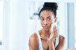 © Chanelle Malambo/peopleimages.com - Skin care, black woman with cotton wipe on face and makeup cleaning with luxury cosmetic product in bathroom. Dermatology, cosmetics and beauty facial, African model with cleansing pad and mock up.