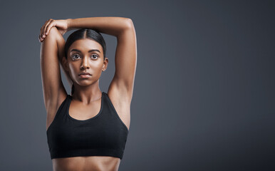 Poster - Fitness, wellness and stretching with an athlete woman in studio on a gray background for mindset or health. Exercise, mission and warm up with an attractive young female model training on mockup