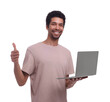 © New Africa - Smiling man with laptop showing thumb up on white background