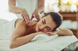 © Viglietti/peopleimages.com - Relax, happy and massage with woman in spa for wellness, luxury and cosmetics treatment. Skincare, peace and zen with female customer and hands of therapist for physical therapy, salon and detox