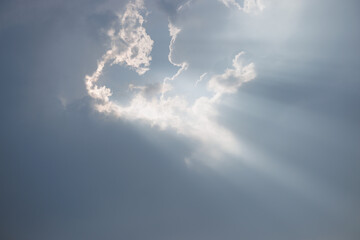 Wall Mural - Dramatic Sky and Sun Rays Background. Sunbeams Light and Moody Cloudscape. Sunbeam through the haze in cloudy day.