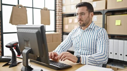 Canvas Print - Young hispanic man ecommerce business worker working relaxed with hands on head at office