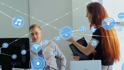 Poster - Animation of network of icons over caucasian businessman and businesswoman discussing at office