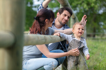 parents with their child in the countryside